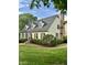 Beautiful two-story home with a classic design, dormer windows, and lush landscaping at 9301 Brookton Ct, Raleigh, NC 27615