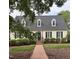 Charming two-story home with a brick pathway, manicured landscaping, and a classic design at 9301 Brookton Ct, Raleigh, NC 27615