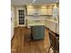 Spacious kitchen with center island, white cabinetry, and hardwood floors at 9301 Brookton Ct, Raleigh, NC 27615