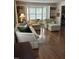 Bright living room with hardwood floors, neutral furniture, and large windows creating a comfortable space at 9301 Brookton Ct, Raleigh, NC 27615
