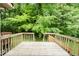 Elevated wooden deck showcasing a view of lush, mature trees at 942 S Fifth St, Mebane, NC 27302