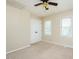 Bedroom featuring neutral carpet, two windows, ceiling fan, and a closet at 942 S Fifth St, Mebane, NC 27302