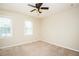 Comfortable bedroom with two windows, ceiling fan, and neutral carpet at 942 S Fifth St, Mebane, NC 27302