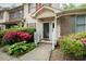 A view of the entrance to a townhome surrounded by colorful landscaping at 942 S Fifth St, Mebane, NC 27302