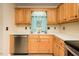 Well-lit kitchen featuring stainless steel appliances and light wood cabinets at 942 S Fifth St, Mebane, NC 27302