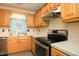 A fully equipped kitchen featuring stainless steel appliances and light wood cabinets at 942 S Fifth St, Mebane, NC 27302