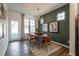 Elegant dining room with a modern chandelier, hardwood floors, and lots of natural light at Lot 7 Cooper St, Sanford, NC 27330