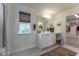Bright bathroom featuring a vanity, window, and view into a closet space, creating a spa-like atmosphere at Lot 8 Cooper St, Sanford, NC 27330