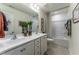 Bright bathroom featuring double sinks, modern vanity, and a shower-tub combo with a stylish shower curtain at Lot 8 Cooper St, Sanford, NC 27330