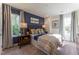 Primary bedroom features a large bed, blue accent wall, and bedside table and lamps at Lot 8 Cooper St, Sanford, NC 27330