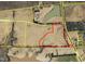 Aerial view of land outlined in red, with surrounding fields, roads and pond at 1 Deer Run Trl, Hillsborough, NC 27278