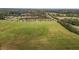 Idyllic aerial view of green fields with scattered hay bales, trees and a pond at 1 Deer Run Trl, Hillsborough, NC 27278