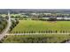Expansive aerial view of green fields with trees and a road in the distance at 1 Deer Run Trl, Hillsborough, NC 27278