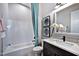 Bathroom with a tub and shower combo, vanity with countertop, and decorative wall art at 1 Deer Run Trl, Hillsborough, NC 27278
