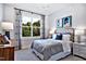 Cozy bedroom with a large window, stylish bed frame, and artistic wall decor at 1 Deer Run Trl, Hillsborough, NC 27278