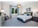 Well-lit bedroom featuring a cozy bed, large window with patterned curtains, and neutral decor at 1 Deer Run Trl, Hillsborough, NC 27278