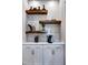 Coffee bar features white cabinets, white countertops, tile backsplash, and open shelves with decor at 1 Deer Run Trl, Hillsborough, NC 27278