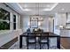 Dining room featuring modern lighting and neutral decor, seamlessly connected to the kitchen for easy entertaining at 1 Deer Run Trl, Hillsborough, NC 27278