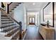Welcoming entryway with wood stairs, a stylish hall table, and a clear view to the home office at 1 Deer Run Trl, Hillsborough, NC 27278