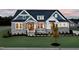 Beautiful two-story home featuring stone accents, fresh landscaping, and a welcoming front porch at 1 Deer Run Trl, Hillsborough, NC 27278