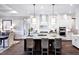 Kitchen with a center island and seating, stainless steel appliances, and seamless transition to the dining area at 1 Deer Run Trl, Hillsborough, NC 27278