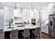 Bright kitchen featuring white cabinets, a large island, stainless steel appliances, and pendant lighting at 1 Deer Run Trl, Hillsborough, NC 27278