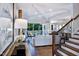 Comfortable living room featuring coffered ceilings, an open floor plan, and access to the back porch at 1 Deer Run Trl, Hillsborough, NC 27278