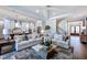 Open-concept living room with hardwood floors and a seamless flow to the kitchen and stairs at 1 Deer Run Trl, Hillsborough, NC 27278