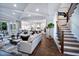 Open-concept living room and kitchen with hardwood floors, coffered ceiling, and ample natural light at 1 Deer Run Trl, Hillsborough, NC 27278