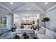 Bright living room showcasing hardwood floors and an open-concept design connecting to the kitchen at 1 Deer Run Trl, Hillsborough, NC 27278
