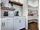 Walk-in pantry with built-in shelves for ample storage, adjacent to a coffee bar with stylish design at 1 Deer Run Trl, Hillsborough, NC 27278