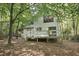 Charming backyard featuring a multi-level deck surrounded by mature trees at 101 Creekview Cir, Carrboro, NC 27510