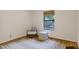 Cozy bedroom area with a view of the wooded outdoors and hardwood flooring throughout at 101 Creekview Cir, Carrboro, NC 27510