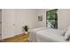 Bright bedroom featuring hardwood floors, a large window, and neutral decor at 101 Creekview Cir, Carrboro, NC 27510