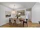 Cozy dining area with a stylish table, decorative light fixture, and hardwood floors at 101 Creekview Cir, Carrboro, NC 27510