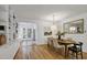 Inviting dining room with hardwood floors, built-in shelving, and natural light from nearby door to the outside at 101 Creekview Cir, Carrboro, NC 27510