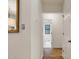 Hallway with hardwood floors that leads to a well-lit bathroom at 101 Creekview Cir, Carrboro, NC 27510