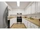 Well-lit kitchen features white cabinets, laminate countertops, and stainless steel appliances at 101 Creekview Cir, Carrboro, NC 27510