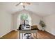 Office space with hardwood floors, desk, and a large arched window overlooking trees at 101 Creekview Cir, Carrboro, NC 27510