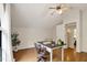 Office space with hardwood floors, desk, and a large arched window overlooking trees at 101 Creekview Cir, Carrboro, NC 27510