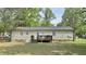 Rear view of the home showcasing a cozy wooden deck overlooking the expansive backyard at 1011 Wyldewood Rd, Durham, NC 27704