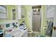 This bathroom features a shower, mirror, and a sink with storage underneath at 1011 Wyldewood Rd, Durham, NC 27704