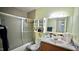 This bathroom features a shower with glass doors, a mirror, and a sink at 1011 Wyldewood Rd, Durham, NC 27704