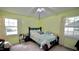 This bedroom features two windows with natural light, a ceiling fan, and carpet at 1011 Wyldewood Rd, Durham, NC 27704