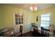 The Dining Room features a door to the outside, a window and wooden furniture at 1011 Wyldewood Rd, Durham, NC 27704