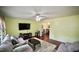 Inviting living room with hardwood floors, a comfortable sofa, and ample natural light at 1011 Wyldewood Rd, Durham, NC 27704