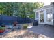 Landscaped backyard with a sunroom, stone patio, mature trees, and a privacy fence for outdoor enjoyment at 1013 Chelsea Run Ln, Apex, NC 27502
