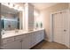 Double vanity bathroom with white cabinetry, modern fixtures, and neutral tile flooring at 1013 Chelsea Run Ln, Apex, NC 27502
