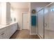 Bright bathroom with double vanity, white cabinetry, and a glass-enclosed shower at 1013 Chelsea Run Ln, Apex, NC 27502