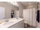 Bathroom featuring a double vanity, white cabinetry, and shower with a curtain at 1013 Chelsea Run Ln, Apex, NC 27502